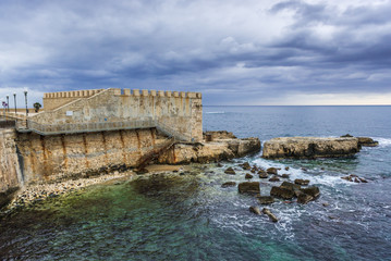 Fototapeta na wymiar View on old walls of Ortygia isle, Syracuse city, Sicily Island in Italy