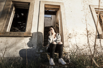 Modelo joven posando en antigua casa en ruinas. Fotografía estilo antiguo