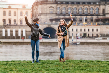 Two beautiful young tourists having fun in old european town