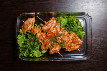 Fresh meat on skewers with herbs and vegetables