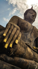 Buddha with cloud and blue sky ,look so peaceful ,at Historical park of the Sukhothai city, Thailand