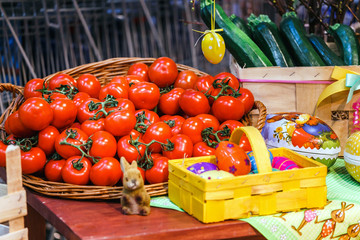 Many juicy tomatoes in basket for sale in a market stall