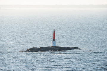 Red beacon on a small rock at a seaway © stefanholm