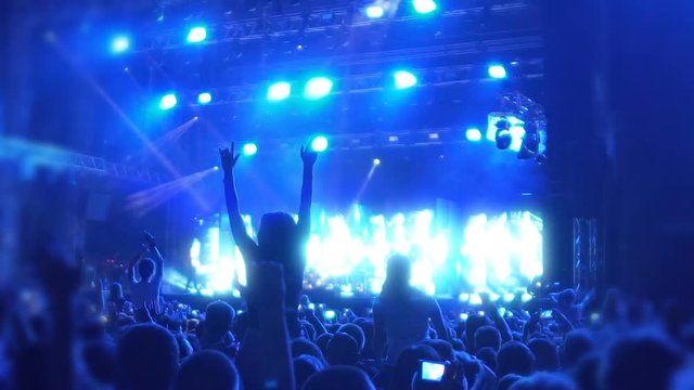 Young people dancing to beats of favorite music at concert, super slowmotion