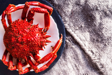 Delicious seafood - Red crab on white plate and rustic sack cloth  background. .