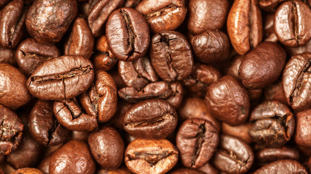 Coffee beans macro on a brown background