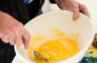 Grandmother preparing batter for pancakes