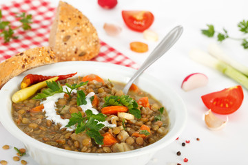 Plate of lentil stew with slices of bread. Vegetarian food.