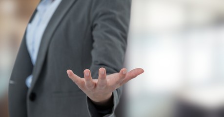 Fototapeta premium Midsection of businesswoman gesturing over blur background