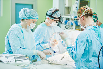 surgeons at work. female nurse operating in child surgery hospital