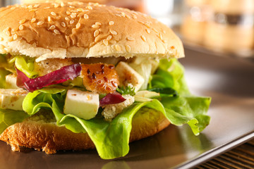Plate with chicken salad in burger bun, closeup