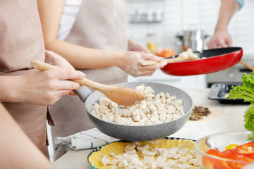 Obraz na płótnie Canvas Group of people preparing food at cooking classes