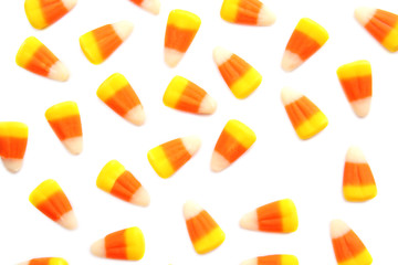 Colorful Halloween candy corns on white background