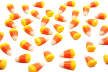 Colorful Halloween candy corns on white background