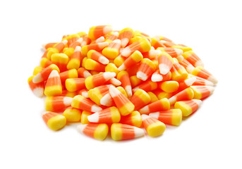 Colorful Halloween candy corns on white background