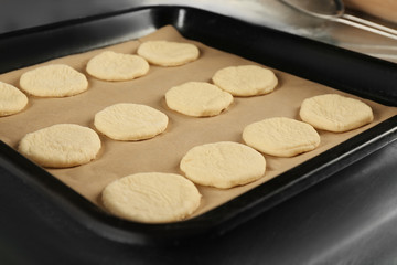 Raw dough for cookies on baking tray, closeup