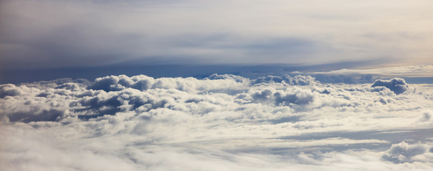 Naklejka na ściany i meble Cloudy sky - view from plane window