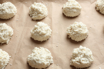 Delicious coconut macaroons on parchment, closeup