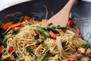 Delicious rice noodle stewing with vegetables on wok