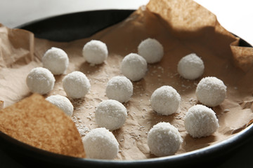 Fototapeta na wymiar Baking tray with coconut candies, closeup