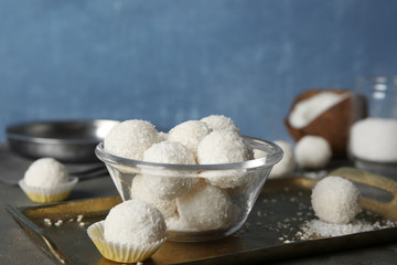 Bowl with coconut candies on metal tray