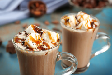 Glass cups of cocoa with marshmallows and syrup, close up