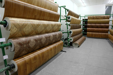Racks with linoleum rolls in wholesale warehouse
