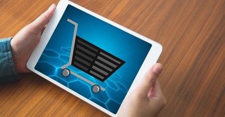 Shopping cart on tablet PC's screen held by woman
