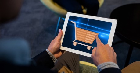Hand touching shopping cart sign on tablet PC