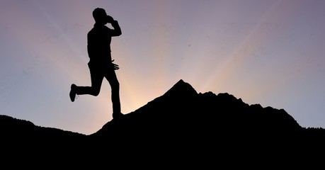 Silhouette businessman using phone and running