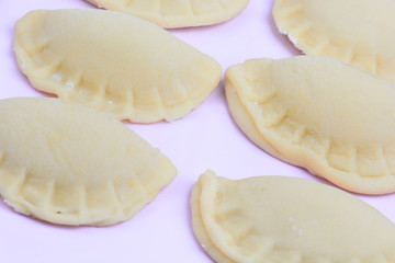 Ravioli on pink background