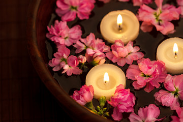 Fototapeta na wymiar Floating candle and flowers