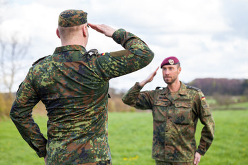 two german soldiers salute each other