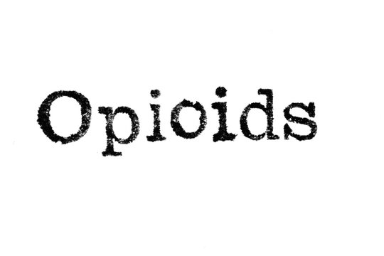 The word "Opioids" from a typewriter on a white background
