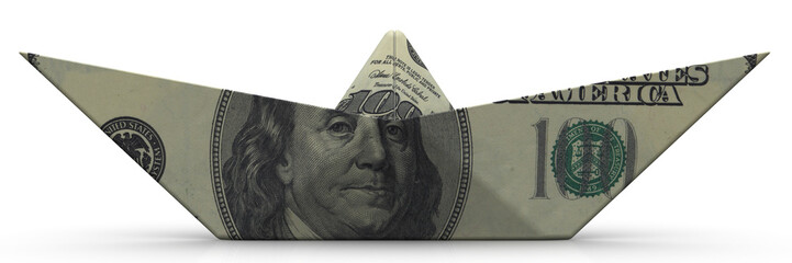 Paper boat from an American banknote on white surface