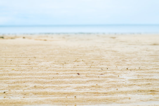 Close Up Beach Sand With Blur Sea At Background