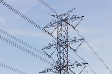 close-up High voltage power transformer substation in cloudy sky background