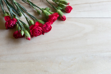 Fototapeta na wymiar Carnation flowers on wooden table