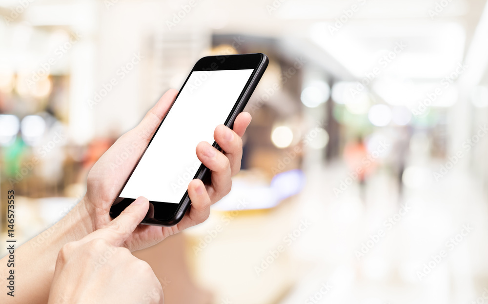 Aufkleber Hand click mobile phone with blur department store background bokeh light,White screen mock up template for adding your design or your text