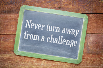 Fototapeta premium Never turn away from a challenge blackboard sign