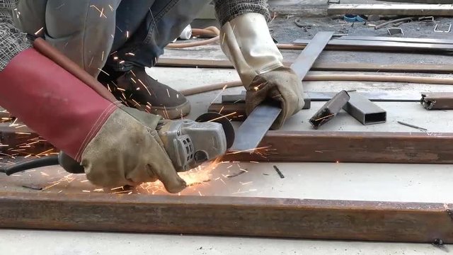 Workers are welding steel, Metal background