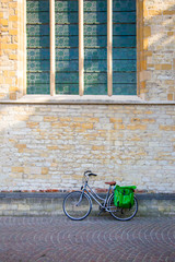 Fototapeta premium Bicycle leaning on old stone wall