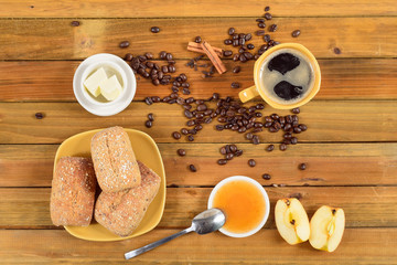 Crispy rolls with butter, apple jelly and hot coffee for breakfast