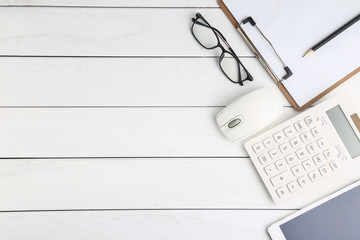 glasses, calculator and tablet on table,business, financial ,investment  concept