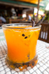 Orange juice mixed with passion fruit juice on white Mozart tile.