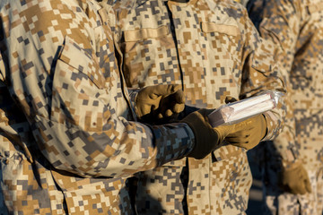 People dressed in soldiers' uniforms, holding a book.