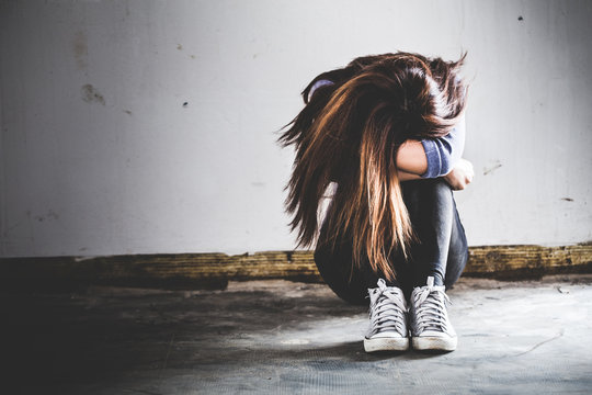 Sad Woman Sitting Alone In A Empty Room. Sressful Concept.