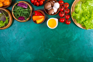 Organic vegetables for dietary catering on green background