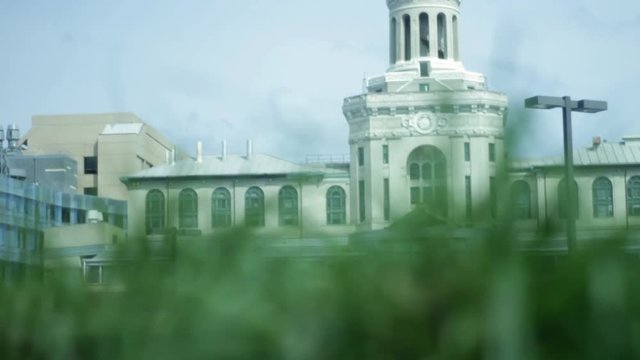 Action Movie Filler Shot - Corporate Building As Seen From Ground Level In Grass