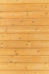 close up of wall made of wooden planks. brown texture background.